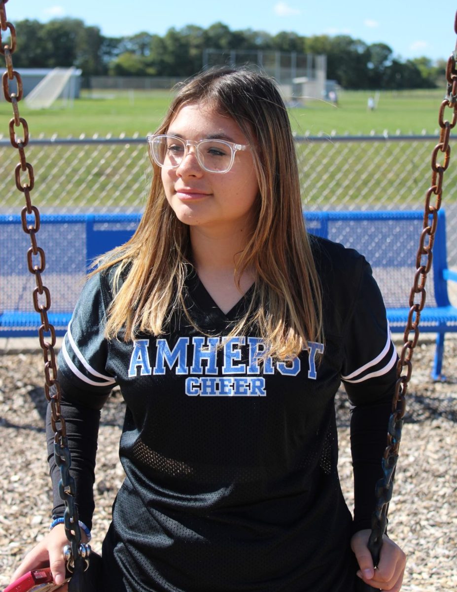 Ilyana sits on the swing thinking of the game to come.