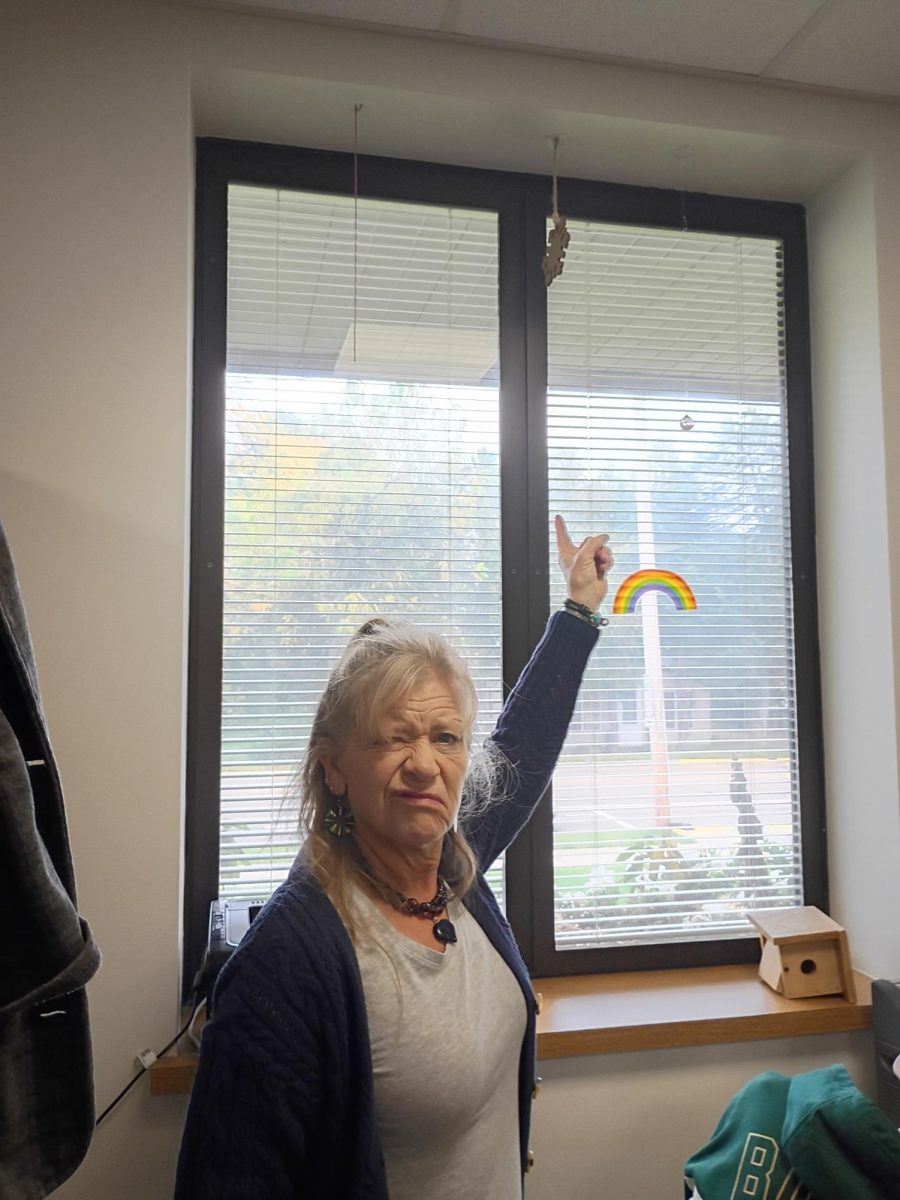 Mrs. Ludeman pointing at the snowflake decoration in her room after she said it's too early to decorate for Christmas.